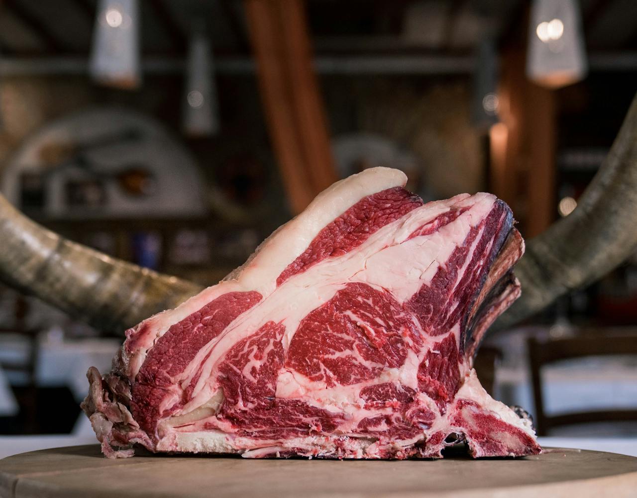 The Art of Drawing Readers In: Your attractive post title goes here High-quality marbled beef rib displayed on a rustic wooden table, showcasing its raw texture and rich colors.